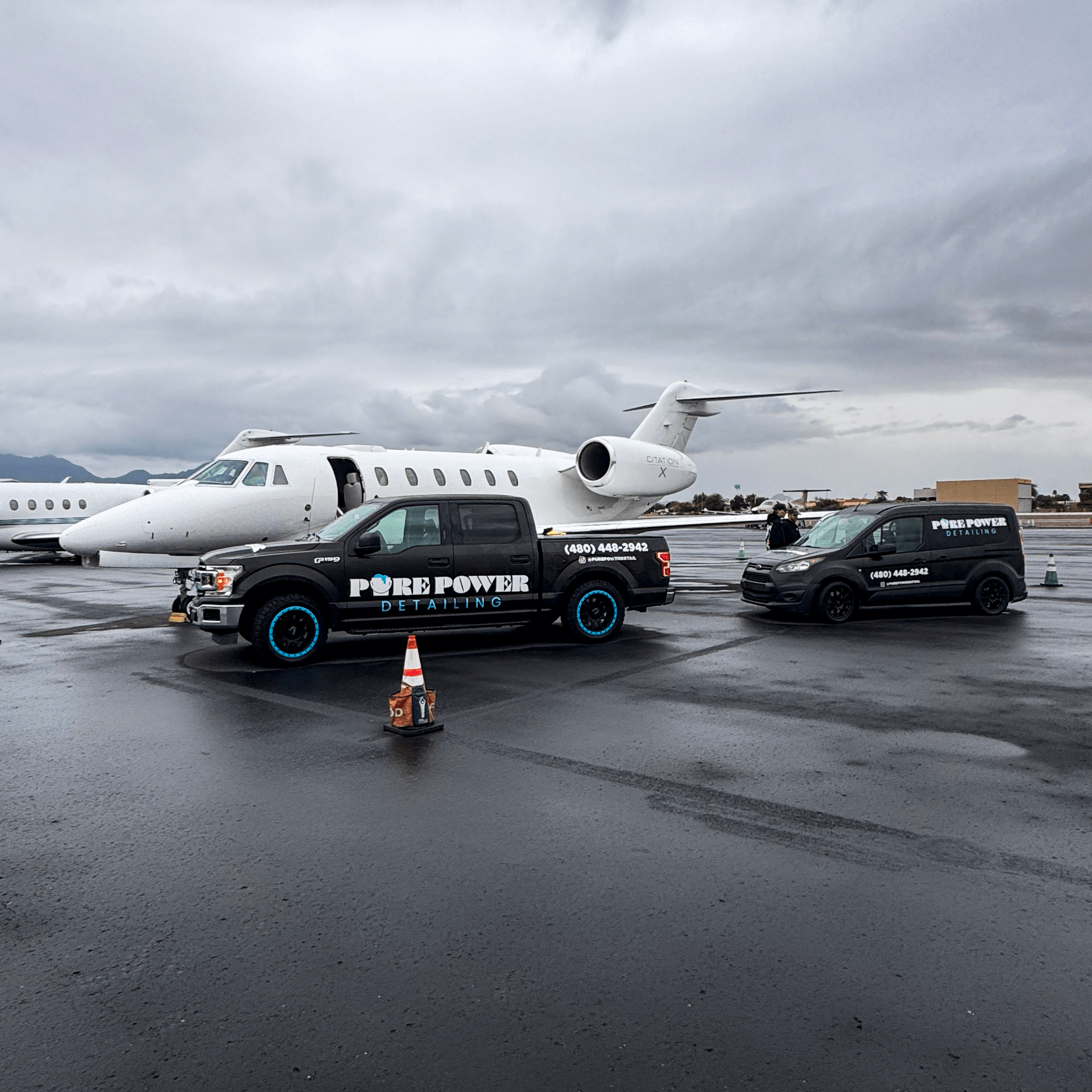 Pure Power Aviation mobile aircraft detailing trucks parked beside private jet on Scottsdale airport ramp