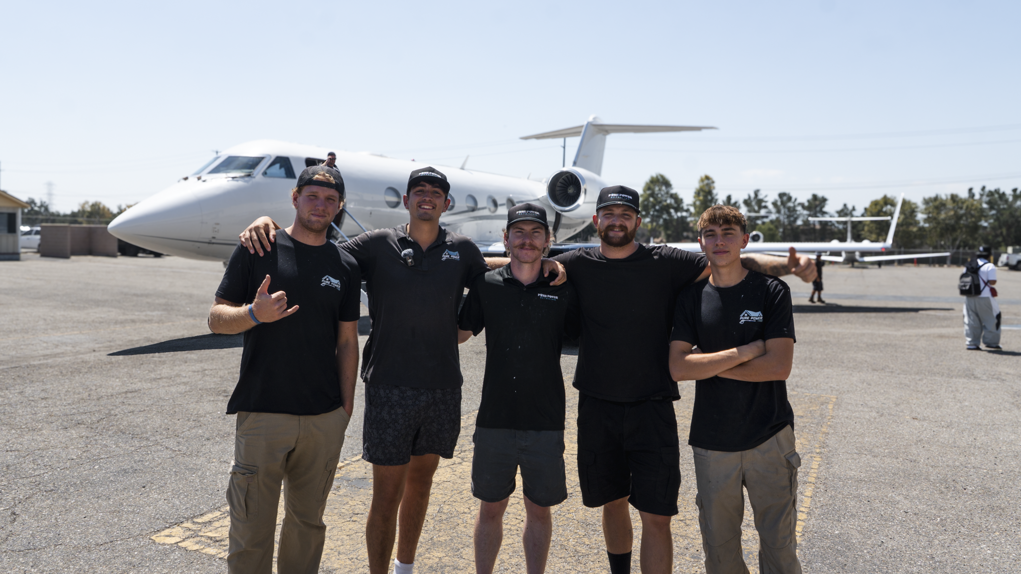 Pure Power Aviation aircraft detailing team standing in front of private jet