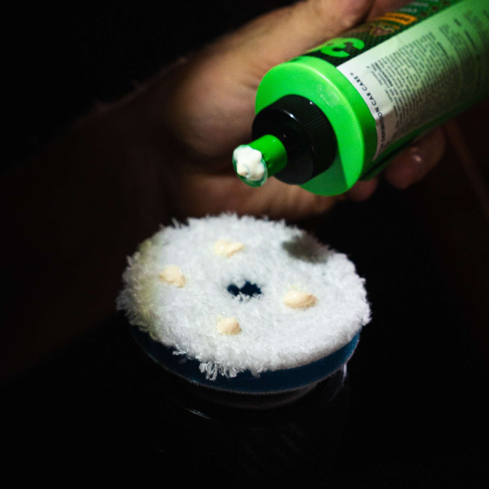 Aircraft paint polishing compound applied to buffer pad during exterior detailing